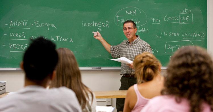 professor pointing to chalk board